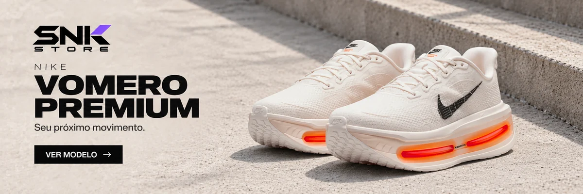 Nike Vomero Premium branco e laranja em cenário de concreto. Seu próximo movimento.